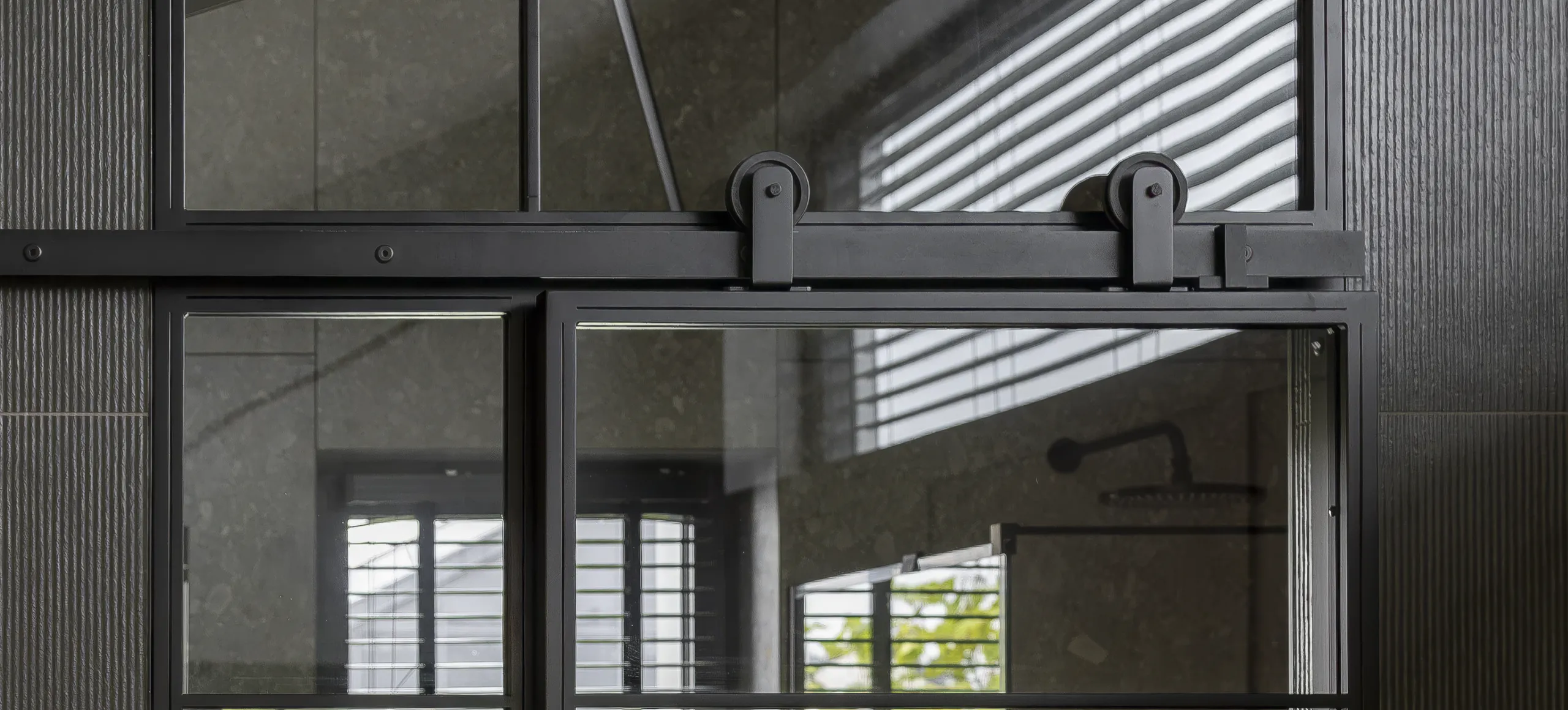 The Barn Bathroom, Richmond: barn-style sliding steel door with a full-height grid