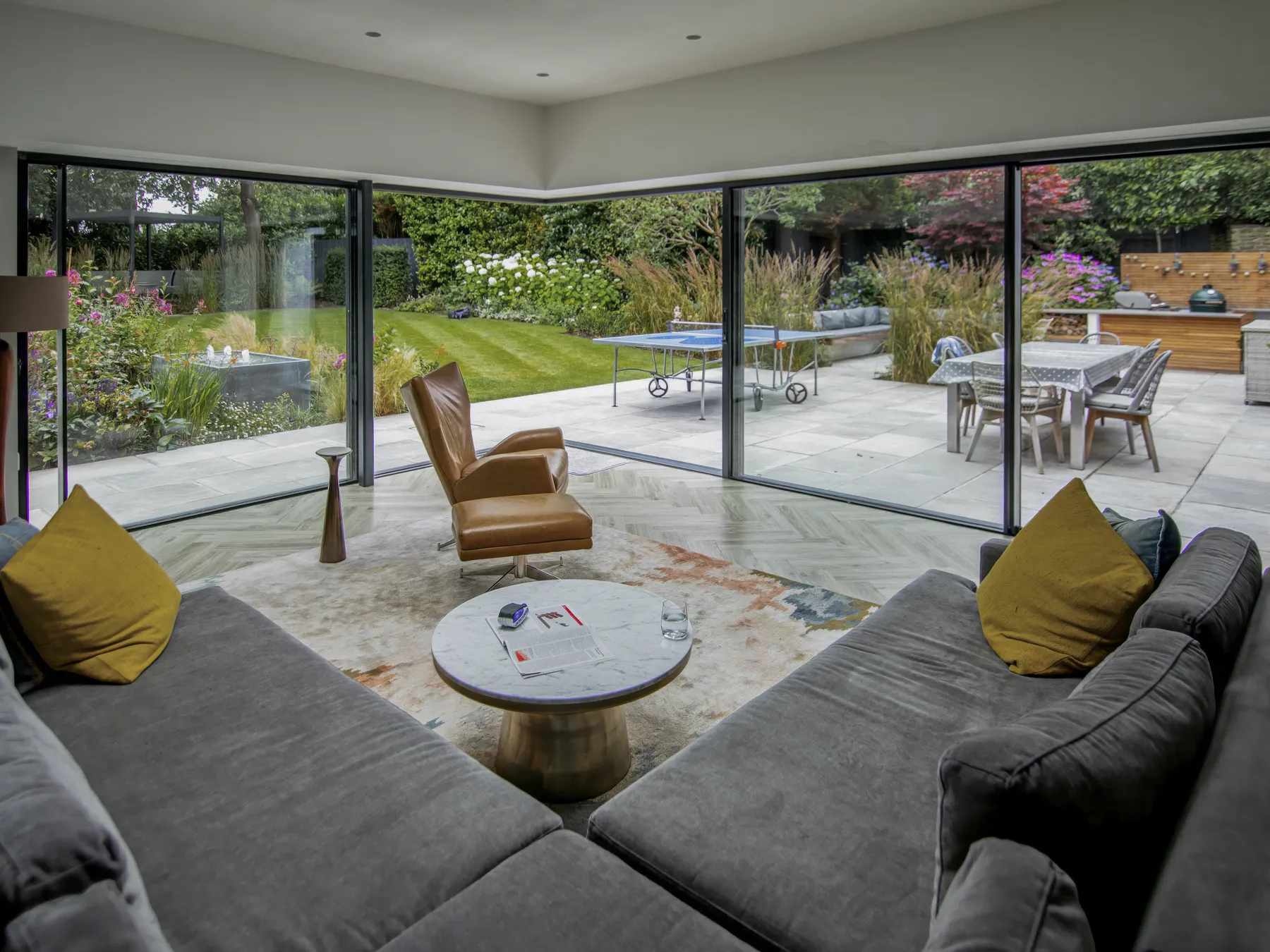 Corner seating looking out through slim sliding glass